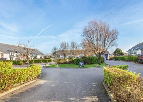 a winding road in a residential neighborhood with houses at Bay Retreat Villas in Saint Merryn