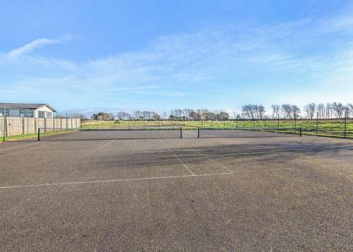 an empty parking lot with a tennis court at Bay Retreat Villas in Saint Merryn