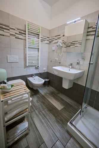 a bathroom with a sink and a toilet and a shower at Il Gelso di Sofia B&B in Tortoreto Lido