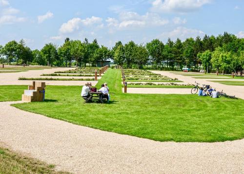 a group of people sitting on benches in a park at Hanworth Country Park in Potter Hanworth