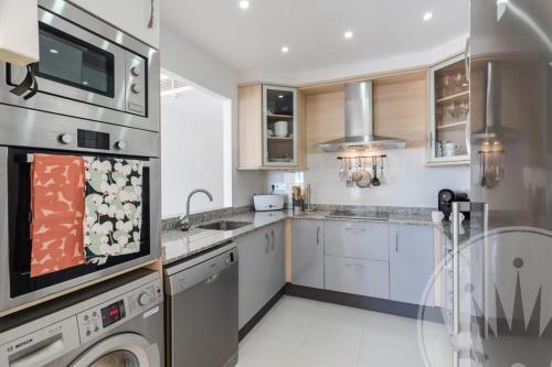 a kitchen with a sink and a dishwasher at La Manga Club - Los Olivos 600 in Atamaría