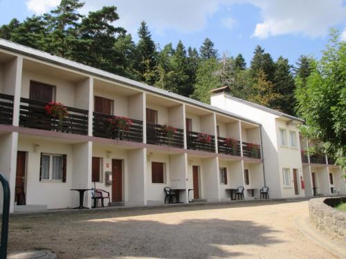an exterior view of a building with trees in the background at Azureva Murol in Murol