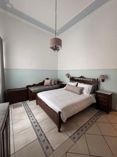 a bedroom with a bed and a couch at Apiro Syros in Ermoupoli