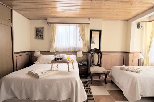 a bedroom with two beds and a table with towels at Hotel Inter Bogotá in Bogotá