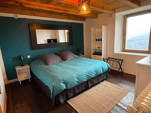 une chambre avec un lit avec un miroir au mur dans l'établissement Mas Soubeyran, à Saint-Michel-de-Dèze