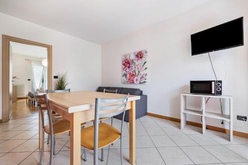 a living room with a table and a tv at Agritur Laura in Nago-Torbole