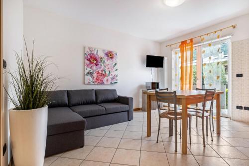 a living room with a couch and a table at Agritur Laura in Nago-Torbole