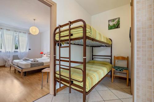 a room with two bunk beds and a bedroom at Agritur Laura in Nago-Torbole