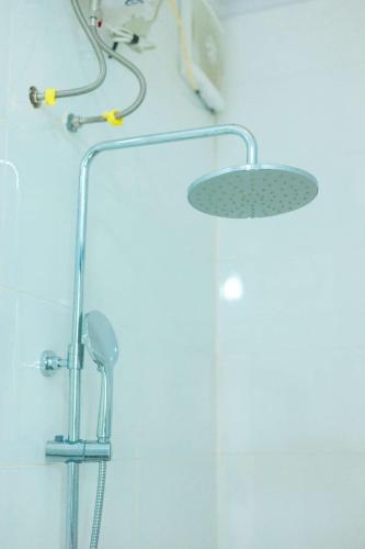 a shower with a shower head on a wall at HDT Farm Stay Thanh Chuong in Thái Nhã