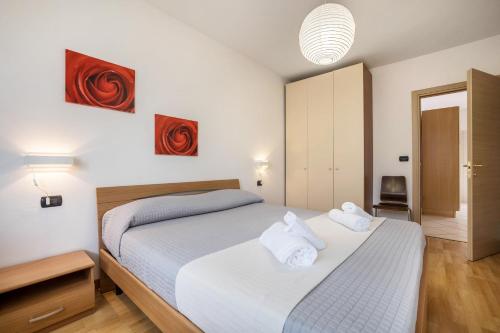 a bedroom with a bed with white towels on it at Agritur Laura in Nago-Torbole