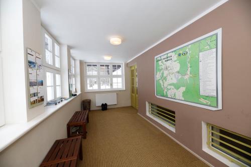 a hallway with two benches and a large map on the wall at Aparthotel Panorama in Deštné v Orlických horách