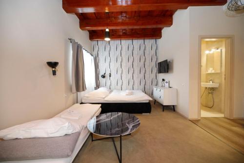 a room with two beds and a table in it at Aparthotel Panorama in Deštné v Orlických horách
