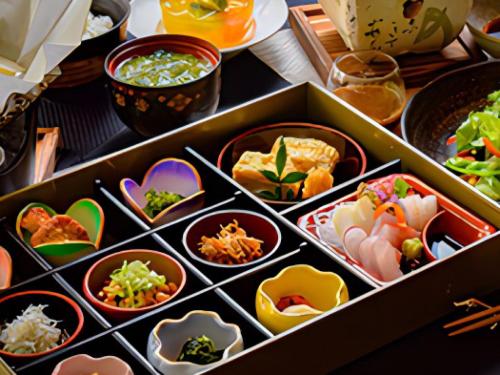 a box filled with different types of food on a table at LiVEMAX Resort Izu Kogen Terrace & Spa in Ito