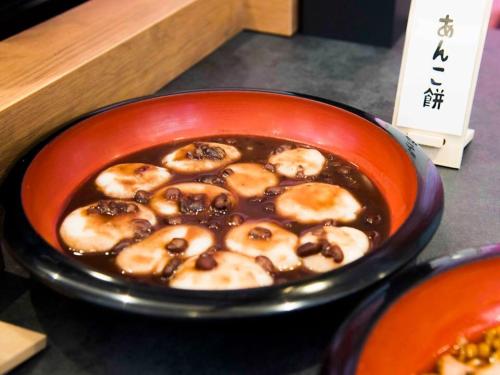 a bowl of food with doughnuts in a bowl at Richmond Hotel Yamagata Ekimae in Yamagata