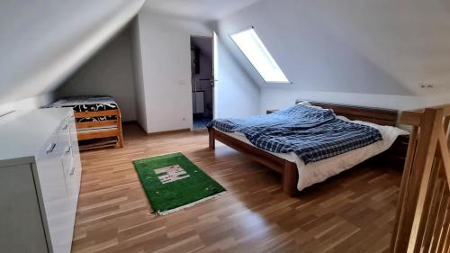 a bedroom with a bed and a green rug at Ferienhaus mit Bergblick auf die Kremsmauer - ruhig und hundefreundlich in Atzeldorf