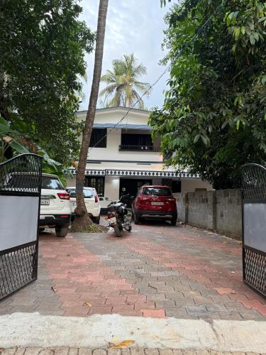 a parking lot with a motorcycle parked in front of a building at Bluebell Home in Kozhikode