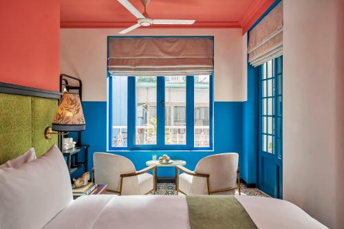 a bedroom with a bed and a table and chairs at Dakao Vibe Studios by CIRCADIAN in Ho Chi Minh City