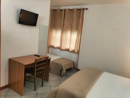 a bedroom with a desk and a bed and a television at Affitta Camere "Le Quercigliole" in Ripalimosani
