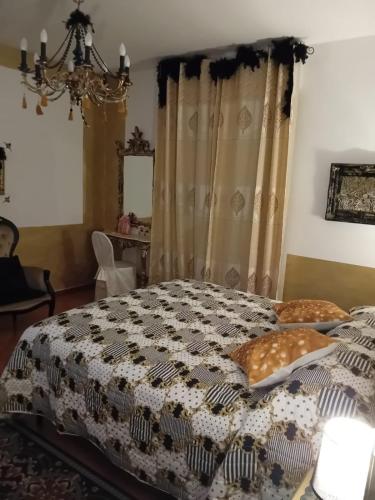 a bedroom with a bed with a black and white quilt at La Sosta in Lunigiana in Monti di Licciana Nardi