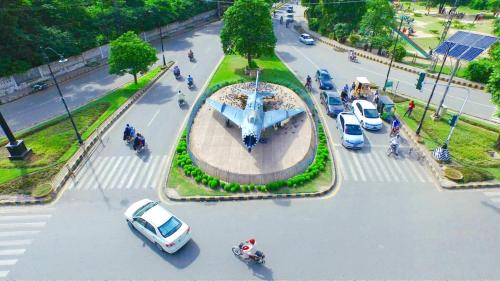 a street with cars parked in a parking lot at Hayyat Luxury Hotel Apartments in Lahore
