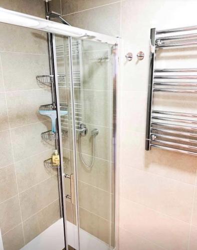 a shower with a glass door in a bathroom at Sol Blanco in Arenales del Sol