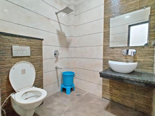 a bathroom with a toilet and a sink at Golden GSC Hotel in Amritsar