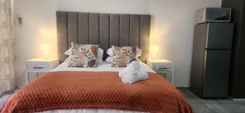 a bedroom with a bed with a stuffed animal on it at Carrington Guesthouse in Kimberley