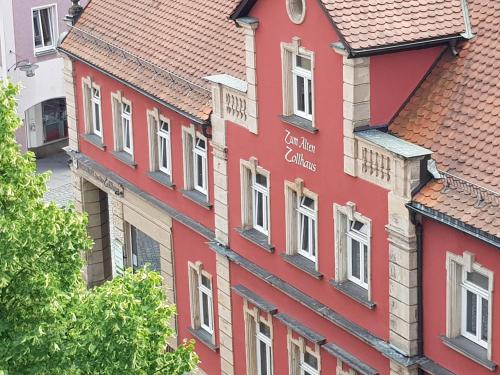 a red building with a sign on the side of it at Stadt Land Fluss New Apartments by Zollhaus in Forchheim