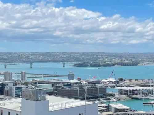 a view of a city with a harbor and a bridge at 180 Degrees Seaview and Harbor View 2 bedroom Apartment in Auckland