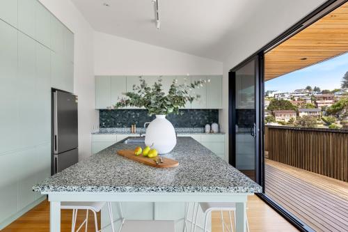 a kitchen with a table with a vase on it at Ourie Place 200m to Werri Beach in Gerringong