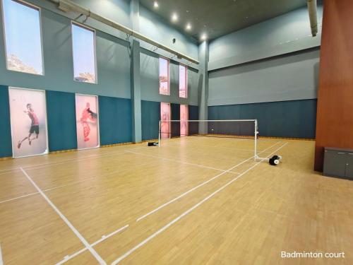 an empty gym with a tennis court with a ball at Ramada by Wyndham Ahmedabad Narendra Modi Stadium Motera in Ahmedabad