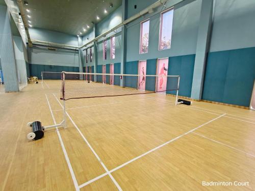 a tennis court with a net in a room at Ramada by Wyndham Ahmedabad Narendra Modi Stadium Motera in Ahmedabad