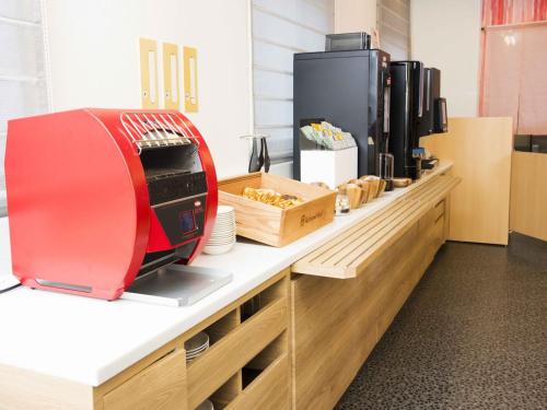 a kitchen with a red toaster on a counter at Richmond Hotel Yamagata Ekimae in Yamagata