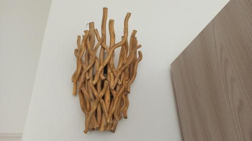 a bunch of branches on a wall at Villa 21 in Budoni