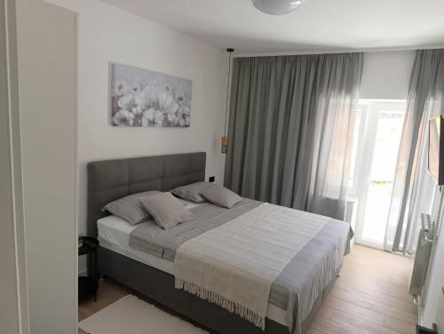 a bedroom with a large bed in a room at Apartman Ladini Lana in Starigrad-Paklenica