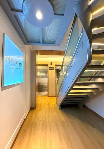 a hallway with an escalator in a building at MyOtel - Santacruz in Mumbai