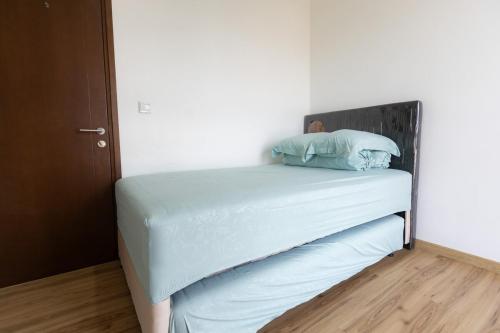 a bed with two pillows on it in a room at Spacious 2 Bedroom Apartment Near SMS Mall in Pumpangsineng