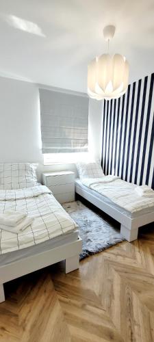 Apartament na wzgórzuにあるベッド