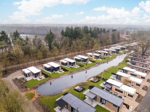 an aerial view of a row of houses next to a river at Veluwepark de Bosgraaf in Apeldoorn