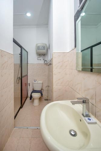 a bathroom with a sink and a toilet at Ceyloni Lake Residency in Kandy