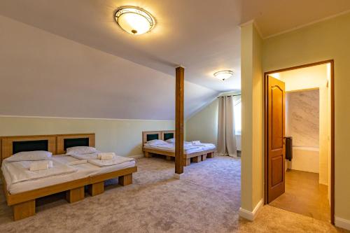 a room with two beds and a hallway at Pension Bella Vista in Sighişoara