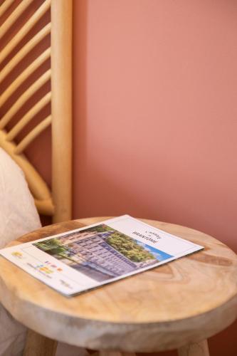a magazine sitting on top of a wooden table at Bel appartement neuf en plein centre in Brantôme