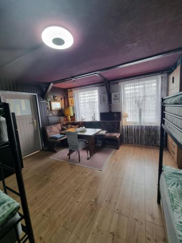 a living room with a table and a couch at Privatzimmer Zur alten Salzstraße in Schnakenbek