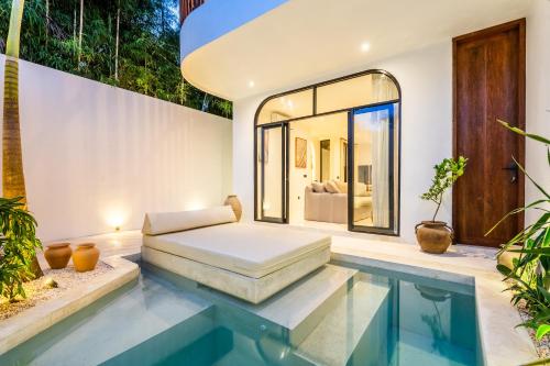 a bedroom with a bed and a swimming pool at Casa Nalani in Kerobokan