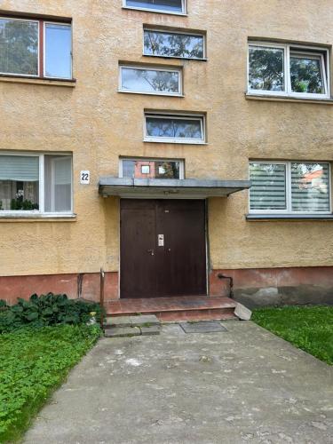 a building with a large door in front of it at Old Town Vytautas Apartment in Klaipėda