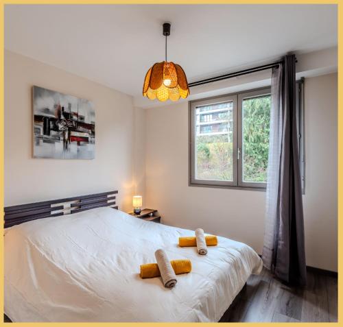 a bedroom with a bed with two towels on it at Chez Dams I T2 I Annecy in Annecy