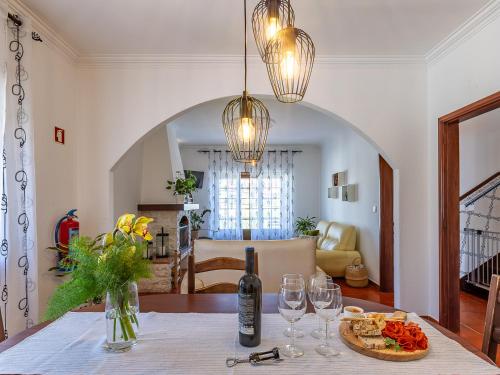 a room with a table with a bottle of wine and glasses at Nº57 House - Ribamar in Santo Isidoro