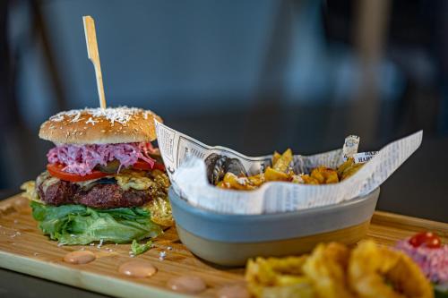 a hamburger and a basket of fries on a table at Pension Bella Vista in Sighişoara