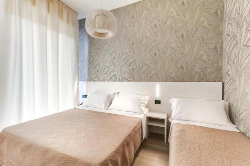 Postel nebo postele na pokoji v ubytování Custodisca Hotel Evolution