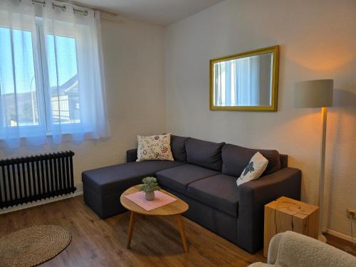 a living room with a couch and a table at Eifelblümchen in Heimbach